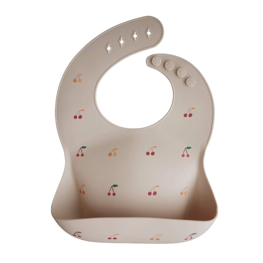 mushie Silicone Baby Bib | Adjustable Fit Waterproof Bibs (Cherries)